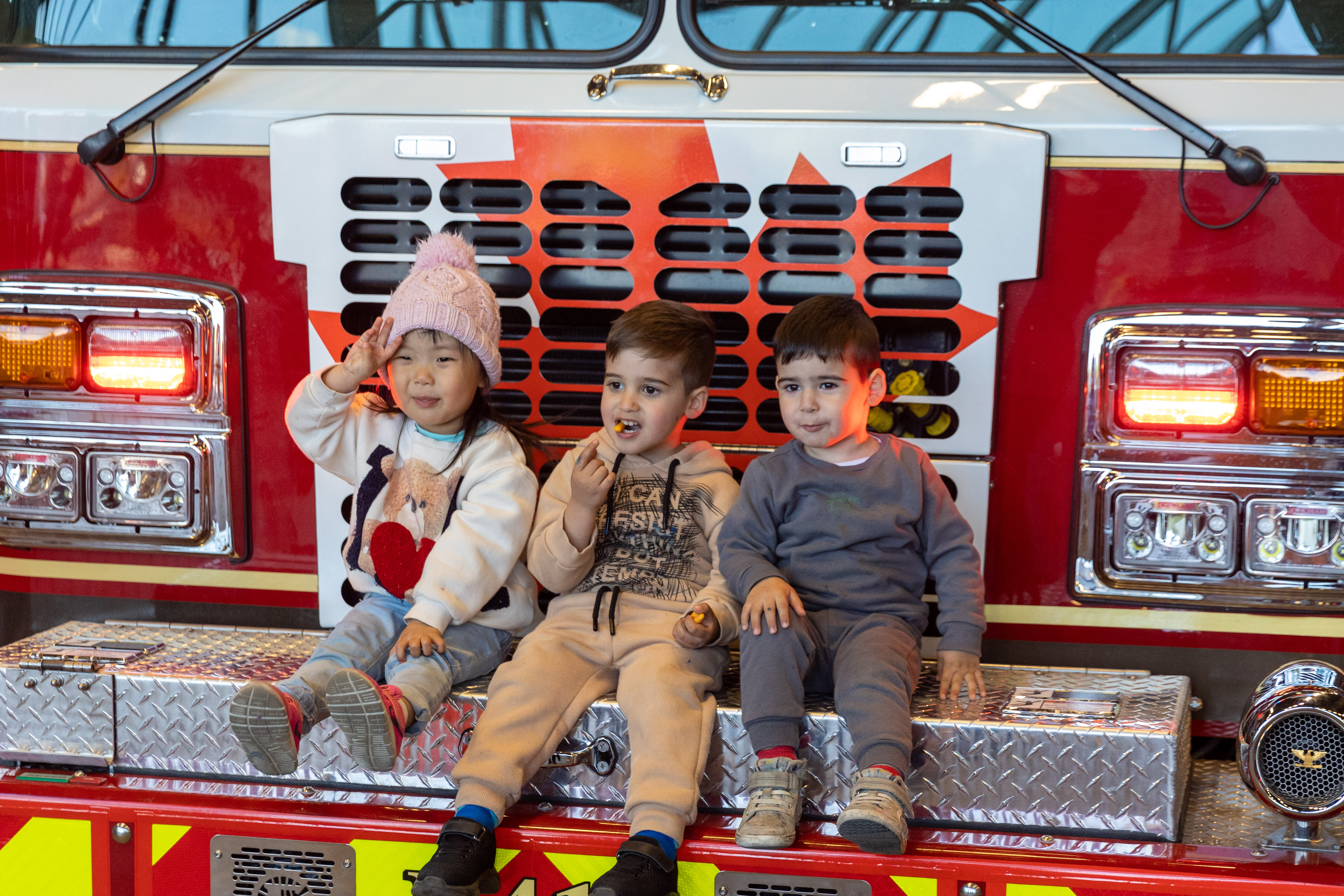 Two children sitting inside front-loader 